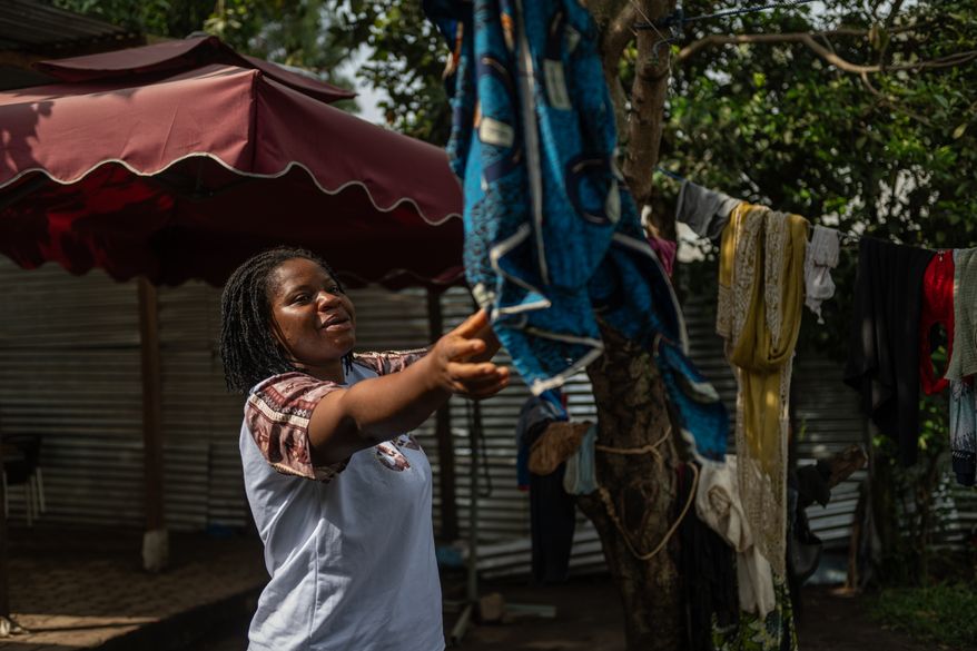 Esther Lutula, a 26 year-old woman who is four months pregnant and a mother of four who stopped going for prenatal checkups shortly after the current Ebola outbreak, does the laundry outside her house in Bunia, northeastern, Congo, Tuesday, June 16, 2026. (AP Photo/Moses Sawasawa)