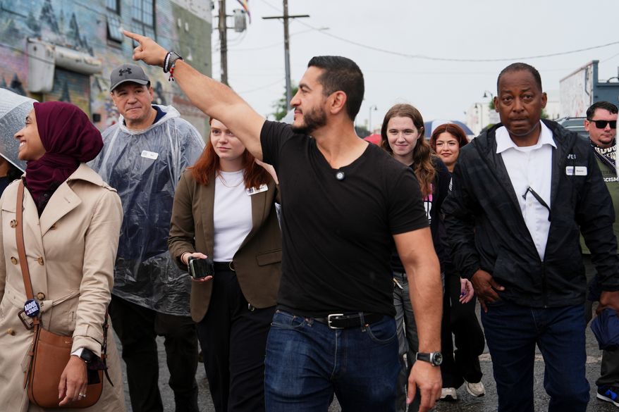 Abdul El-Sayed, a progressive candidate in the Democratic primary for U.S. Senate in Michigan, walks from Anthology Coffee to the Spirit of Detroit during the March of the Many, Sunday, Aug. 2, 2026, in Detroit. (AP Photo/Julia Demaree Nikhinson)