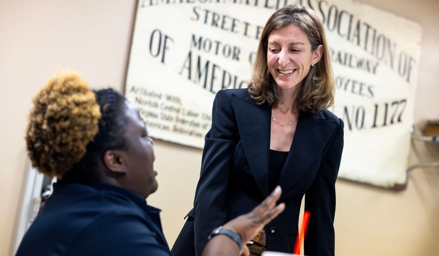 Former Rep. Elaine Luria, D-Va., speaks with Amalgamated Transit Union Local 1177 member Terraine Little on Thursday, July 9, 2026, in Norfolk, Va. (AP Photo/Kendall Warner)