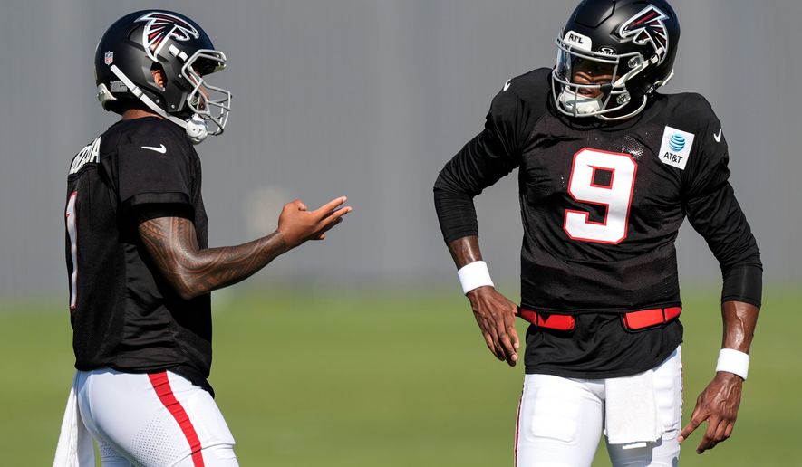 Atlanta Falcons quarterback Michael Penix Jr. (9) and Tua Tagovailoa speak during a Atlanta Falcons training camp, Monday, Aug. 3, 2026, in Flowery Branch, Ga. (AP Photo/Mike Stewart)