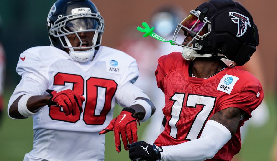 Atlanta Falcons Zachariah Branch (17) works for a catch against Darnay Holmes during a Atlanta Falcons training camp, Monday, Aug. 3, 2026, in Flowery Branch, Ga. (AP Photo/Mike Stewart)