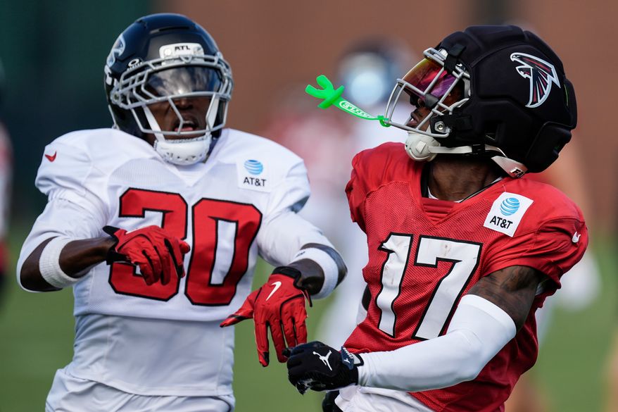 Atlanta Falcons Zachariah Branch (17) works for a catch against Darnay Holmes during a Atlanta Falcons training camp, Monday, Aug. 3, 2026, in Flowery Branch, Ga. (AP Photo/Mike Stewart)
