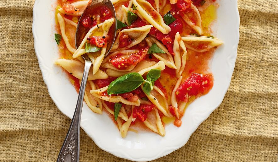 This image released by Voracious shows a recipe for no-cook tomato sauce from "Pasta Every Day" by Meryl Feinstein. (Nico Schinco/Voracious via AP)