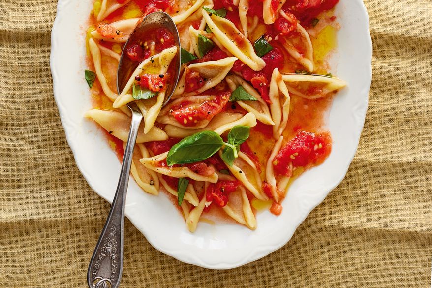 This image released by Voracious shows a recipe for no-cook tomato sauce from "Pasta Every Day" by Meryl Feinstein. (Nico Schinco/Voracious via AP)