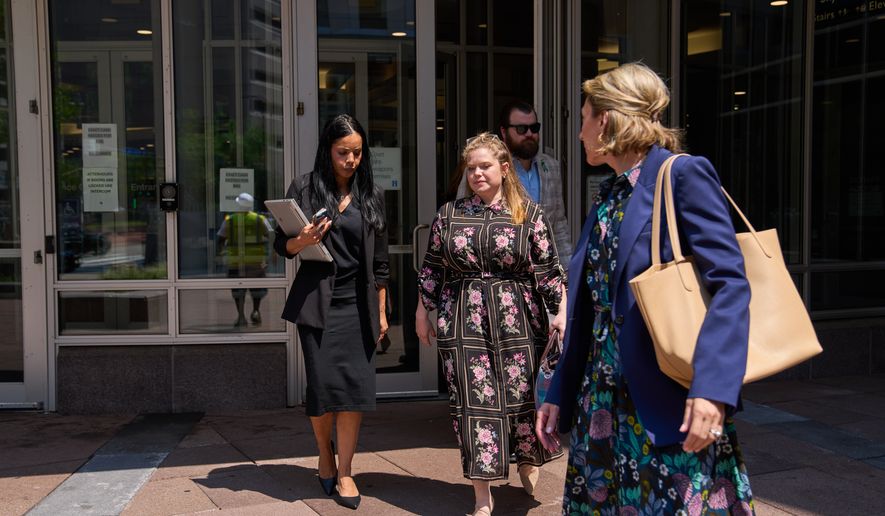 Colin Hortman, behind, son of Melissa and Mark Hortman, and his wife Alina Bachman Hortman, second from left, leave after attending the initial state court appearance for Vance Boelter, Monday, Aug. 3, 2026, in Minneapolis. (AP Photo/Ellen Schmidt)