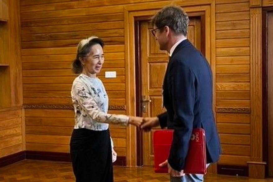 In this photo released by Myanmar President Office on Monday, Aug. 3, 2026, Myanmar's ousted leader Aung San Suu Kyi, left, shakes hands with Arnaud de Baecque, resident representative of the International Committee of the Red Cross, during their meeting in Naypyitaw, Myanmar. (Myanmar President Office via AP)