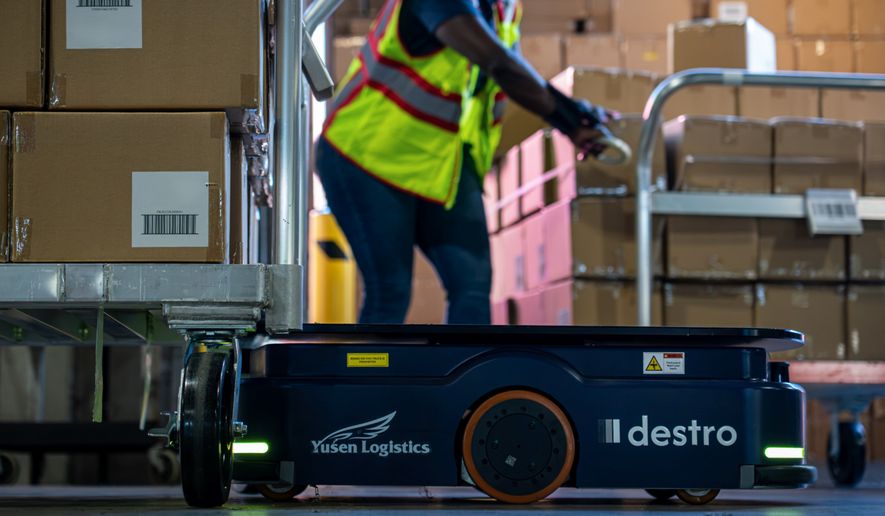 A Destro autonomous robot operating alongside a warehouse associate at a Yusen Logistics facility, demonstrating the companies’ collaboration to improve warehouse operations through intelligent automation.