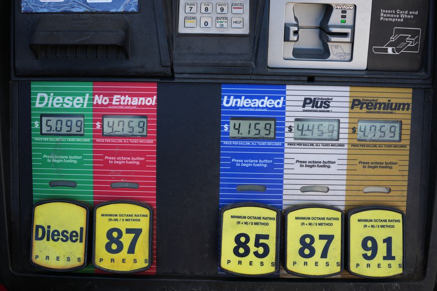 The per-gallon price is displayed electronically over the various grades of fuel available from a pump at a QT gasoline station Thursday, July 30, 2026, in Greenwood Village, Colo. (AP Photo/David Zalubowski)