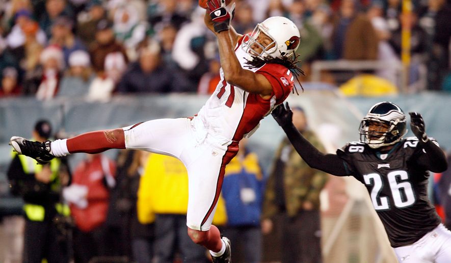 FILE - Arizona Cardinals wide receiver Larry Fitzgerald catches a pass in front of Philadelphia Eagles cornerback Lito Sheppard in the fourth quarter of an NFL football game in Philadelphia, Nov. 27, 2008. (AP Photo/Tom Mihalek, File)