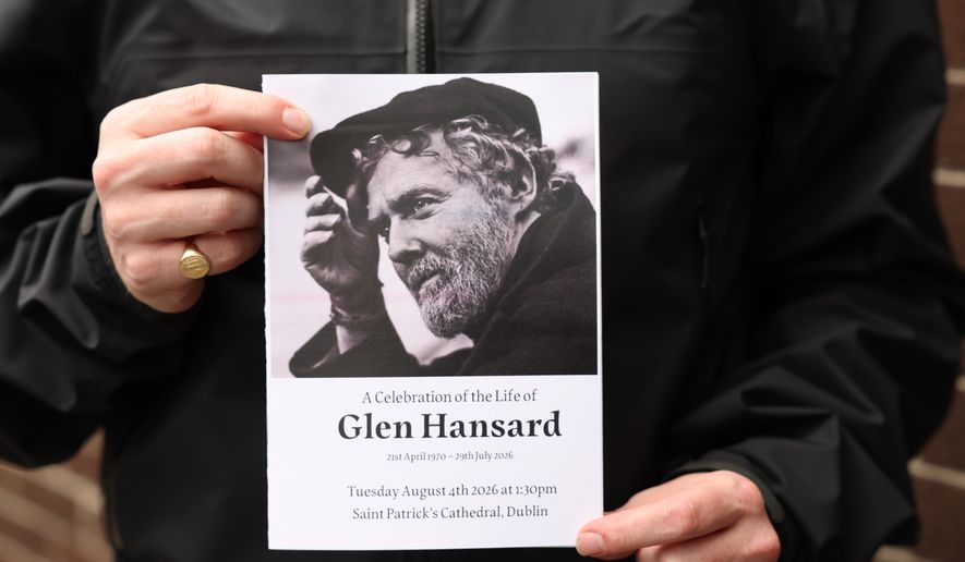 The Order of Service is held up ahead of the funeral of Glen Hansard at St Patrick's Cathedral in Dublin, Tuesday, Aug. 4, 2026. (Damien Eagers/PA via AP)
