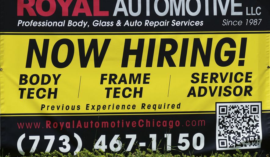 FILE - A now hiring sign is seen in front of an auto body shop in Chicago, June 25, 2026. (AP Photo/Nam Y. Huh, file)