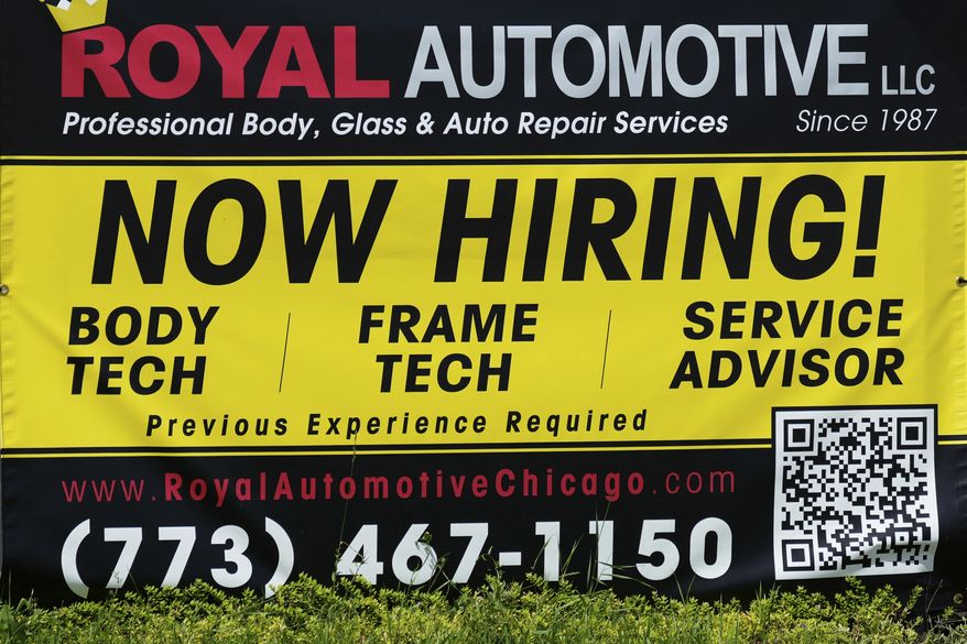 FILE - A now hiring sign is seen in front of an auto body shop in Chicago, June 25, 2026. (AP Photo/Nam Y. Huh, file)