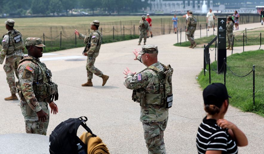 Members of the National Guard patrol around the Washington Monument, before Marine One, with President Donald Trump aboard, departs near the White House, Friday, July 17, 2026, in Washington. (AP Photo/Rahmat Gul)