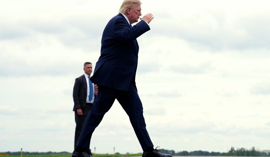 President Donald Trump walks to board Air Force One at Morristown Municipal Airport, in Morristown, N.J., Sunday, Aug. 2, 2026, en route to return to Washington. (AP Photo/Jacquelyn Martin)