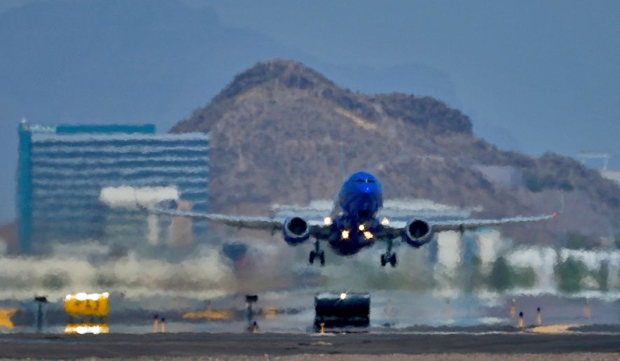 A jet takes flight as heat ripples radiate from the runway at Sky Harbor International Airport in Phoenix, on July 25, 2023. (AP Photo/Matt York, File)