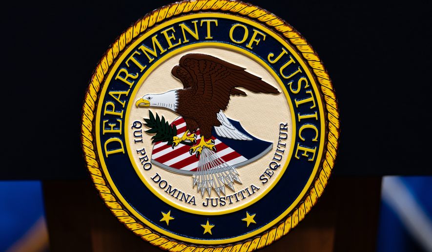 FILE - The U.S. Department of Justice logo is seen on a podium before a news conference, May 4, 2026, in Washington. (AP Photo/Julia Demaree Nikhinson, File)