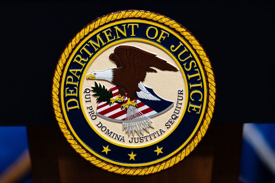 FILE - The U.S. Department of Justice logo is seen on a podium before a news conference, May 4, 2026, in Washington. (AP Photo/Julia Demaree Nikhinson, File)