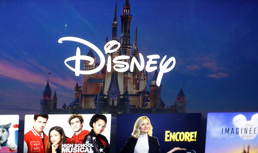 FILE - In this Nov. 13, 2019 file photo, a Disney logo forms part of a menu for the Disney Plus movie and entertainment streaming service on a computer screen in Walpole, Mass. (AP Photo/Steven Senne, File)