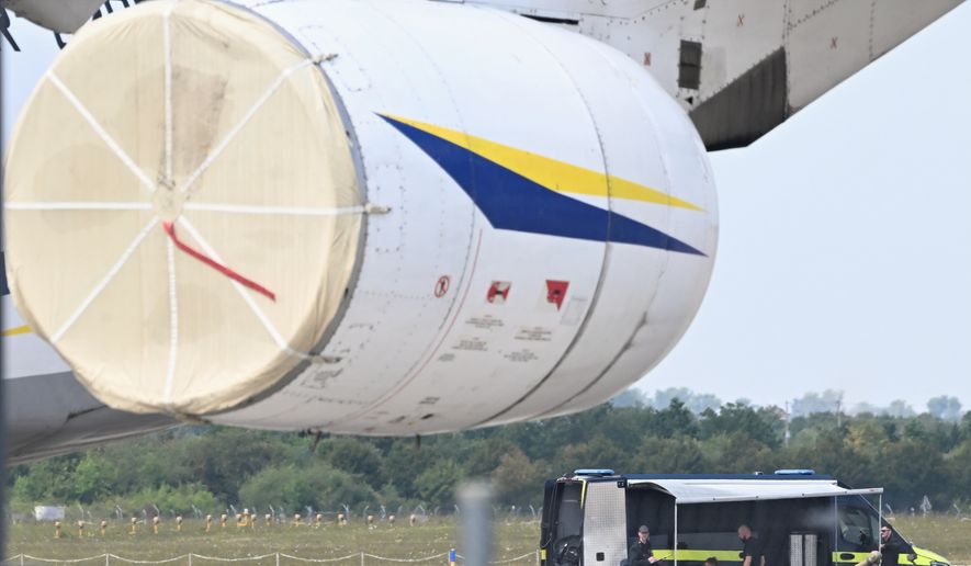 Police forensic technicians prepare to deploy an explosive-disposal robot near a Ukrainian aircraft at Leipzig/Halle Airport, in Schkeuditz, Germany, Wednesday Aug. 5, 2026, where flight operations were suspended overnight after a drone sighting was reported and another object was found near a runway. (Hendrik Schmidt/dpa via AP)