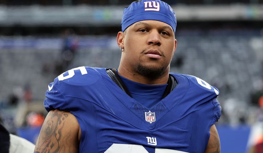 FILE - New York Giants defensive tackle Roy Robertson-Harris (95) walks off the field after an NFL football game against the Dallas Cowboys, Jan. 4, 2026, in East Rutherford, N.J. (AP Photo/Adam Hunger, File)