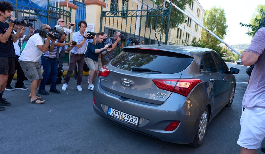 A car carrying an Afghan man accused of killing Scottish woman Elisabeth Jane Ross enters the courthouse for a court appearance in Athens, Greece, Wednesday, Aug. 5, 2026. (AP Photo/Petros Giannakouris)