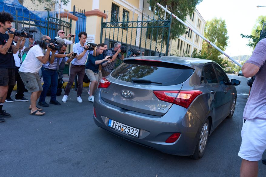 A car carrying an Afghan man accused of killing Scottish woman Elisabeth Jane Ross enters the courthouse for a court appearance in Athens, Greece, Wednesday, Aug. 5, 2026. (AP Photo/Petros Giannakouris)