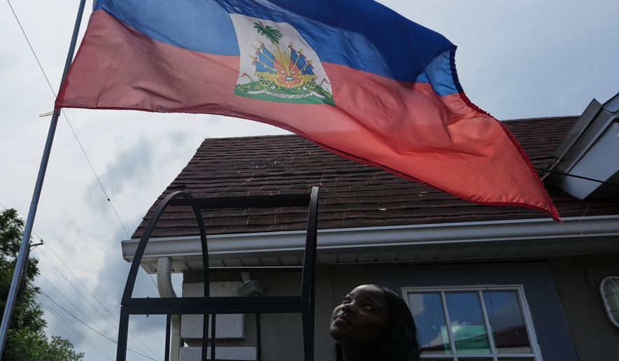Patricia Grace Louis-Jacques, a nursing student who has close Haitian family members and friends affected by the end of TPS, poses for a photo outside the Caribbean Creole Café in Salisbury, Md., Sunday, Aug. 2, 2026. (AP Photo/Luis Andres Henao)