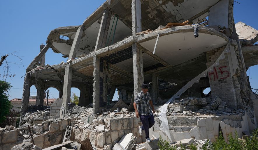 A Lebanese man checks a destroyed house in the village of Zawtar al-Gharbieh, south Lebanon, Wednesday, Aug. 5, 2026. (AP Photo/Mohammed Zaatari)