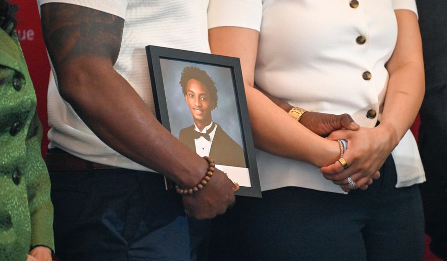 Christine Wonsley and Elmore Wonsley, mother and step father of Nolan Wells, stand on a stage with a photo of their son as they appear at the National Urban League's annual conference to share updates on his death, as well as Daniel Erving, and Tyler Smith, Thursday, July 30, 2026, in Nashville, Tenn. (AP Photo/John Amis)