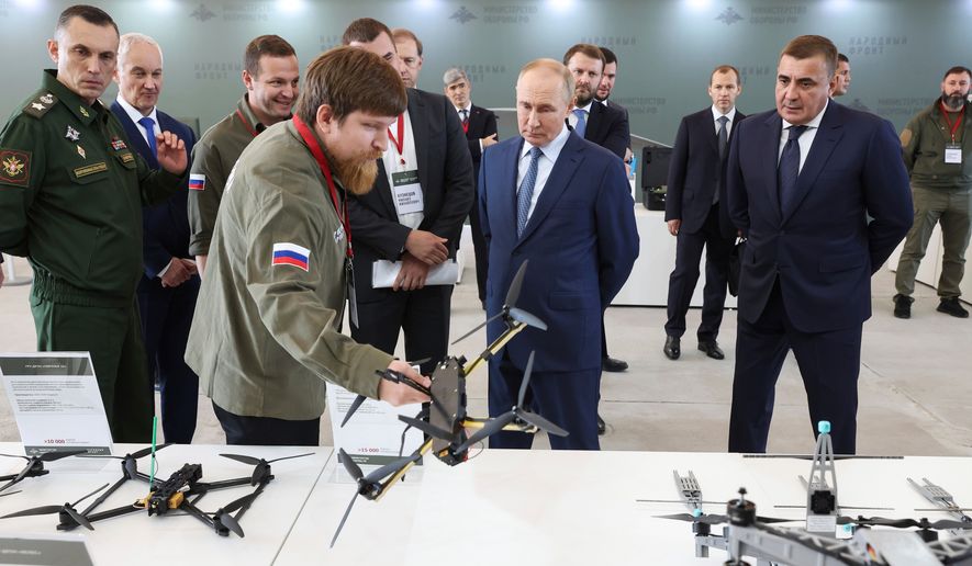 Russian President Vladimir Putin, center, speaks with Vladimir Tkachuk, front, the head of Uraldronzavod, during his visit to the Special Technology Centre in St. Petersburg, Russia, Thursday, Sept. 19, 2024. (Valeriy Sharifulin, Sputnik, Kremlin Pool Photo via AP, File)