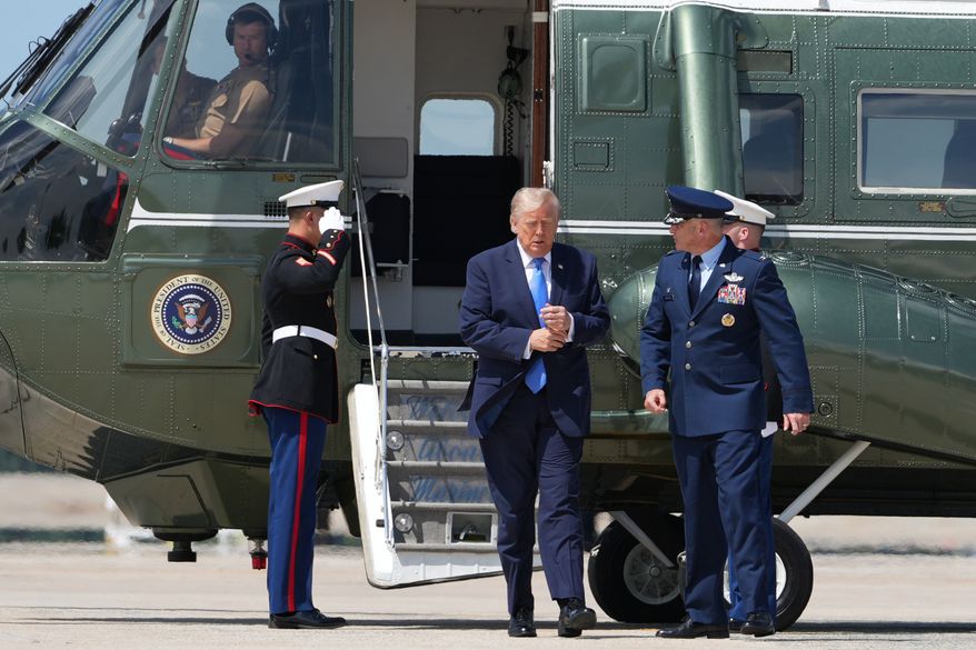 President Donald Trump walks from Marine One with Air Force Col. Christopher M. Robinson, commander of the 89th Airlift Wing, to board Air Force One, Tuesday, Aug. 4, 2026, at Joint Base Andrews, Md. (AP Photo/Mark Schiefelbein)