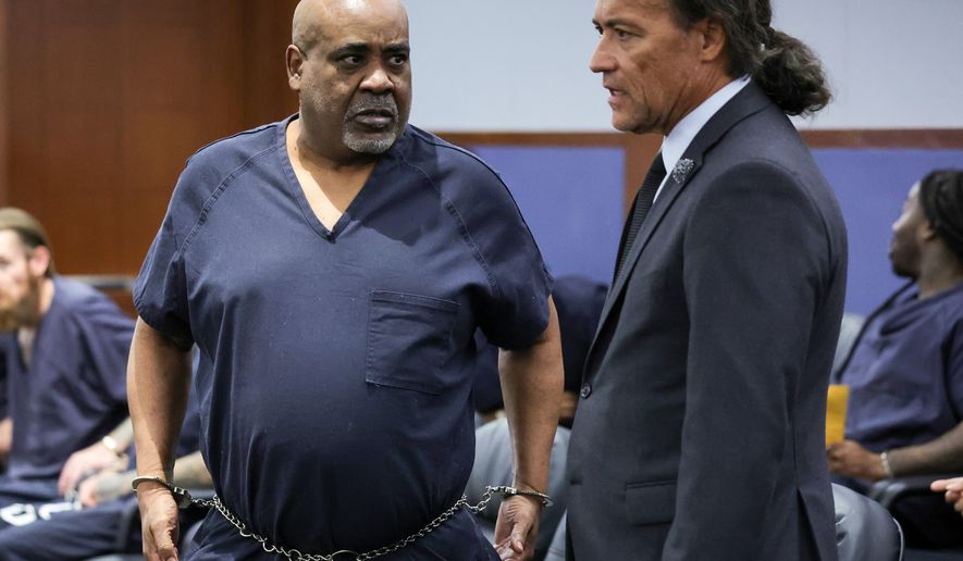 Duane Davis, left, talks with his attorney Michael Sanft in Clark County District Court during a calendar call and motion hearing for Davis' upcoming trial, Tuesday, Aug. 4, 2026, in Las Vegas. (Ethan Miller/Pool Photo via AP)
