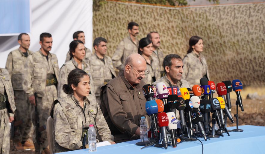 FILE - Kurdistan Workers' Party (PKK) fighters, who reportedly withdrew from Turkey with their weapons, stand to attention during a ceremony in the Qandil area of northern, Iraq, Sunday, Oct 26, 2025. (AP Photo/Rashid Yahya, File)