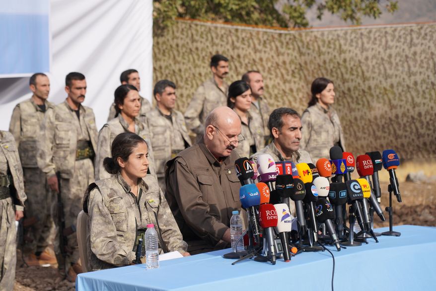 FILE - Kurdistan Workers' Party (PKK) fighters, who reportedly withdrew from Turkey with their weapons, stand to attention during a ceremony in the Qandil area of northern, Iraq, Sunday, Oct 26, 2025. (AP Photo/Rashid Yahya, File)