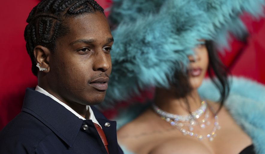 ASAP Rocky, left and Rihanna, pose for photographers upon arrival at the The Fashion Awards 2024 on Monday, Dec. 2, 2024, in London. (Photo by Scott A Garfitt/Invision/AP)