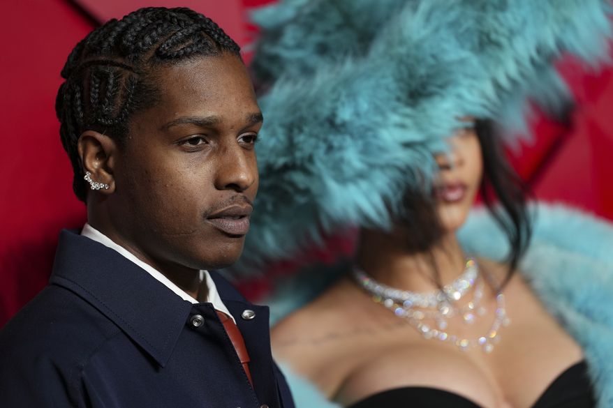 ASAP Rocky, left and Rihanna, pose for photographers upon arrival at the The Fashion Awards 2024 on Monday, Dec. 2, 2024, in London. (Photo by Scott A Garfitt/Invision/AP)