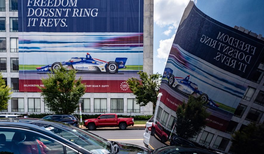 A sign on a building along the route for the upcoming Freedom 250 Grand Prix promotes the event, Friday, July 31, 2026, in Washington. (AP Photo/Alex Brandon)