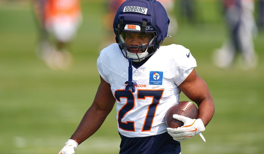 Denver Broncos running back J.K. Dobbins takes part in drills during a practice at the team's NFL football training camp Tuesday, Aug. 4, 2026, in Centennial, Colo. (AP Photo/David Zalubowski)