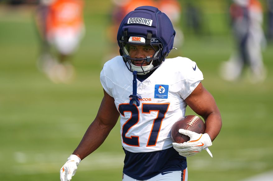 Denver Broncos running back J.K. Dobbins takes part in drills during a practice at the team's NFL football training camp Tuesday, Aug. 4, 2026, in Centennial, Colo. (AP Photo/David Zalubowski)