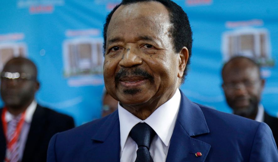 FILE - Cameroon's President Paul Biya, of the Cameroon People's Democratic Movement party, waits to cast his vote during the presidential elections, Oct. 7, 2018, in Yaounde, Cameroon. (AP Photo/Sunday Alamba, File)