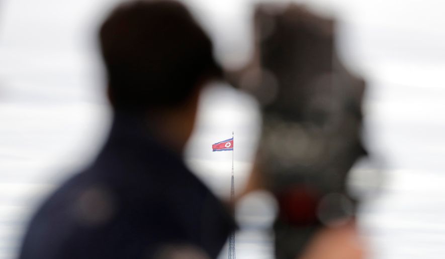 A North Korean flag flutters in the wind atop a 160-meter tower in North Korea's village Gijungdong as seen from the Taesungdong freedom village inside the demilitarized zone in Paju, South Korea on April 24, 2018. (AP Photo/Lee Jin-man, File)