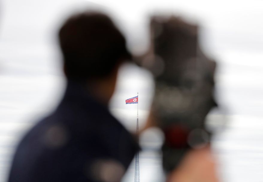 A North Korean flag flutters in the wind atop a 160-meter tower in North Korea's village Gijungdong as seen from the Taesungdong freedom village inside the demilitarized zone in Paju, South Korea on April 24, 2018. (AP Photo/Lee Jin-man, File)