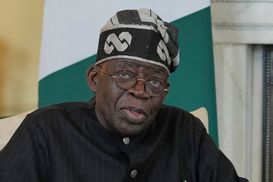 Nigerian President Bola Tinubu speaks to the media ahead of his meeting with Britain's then-Prime Minister Keir Starmer (not shown) inside 10 Downing Street in London, Thursday, March 19, 2026. (AP Photo/Kin Cheung, Pool, File)
