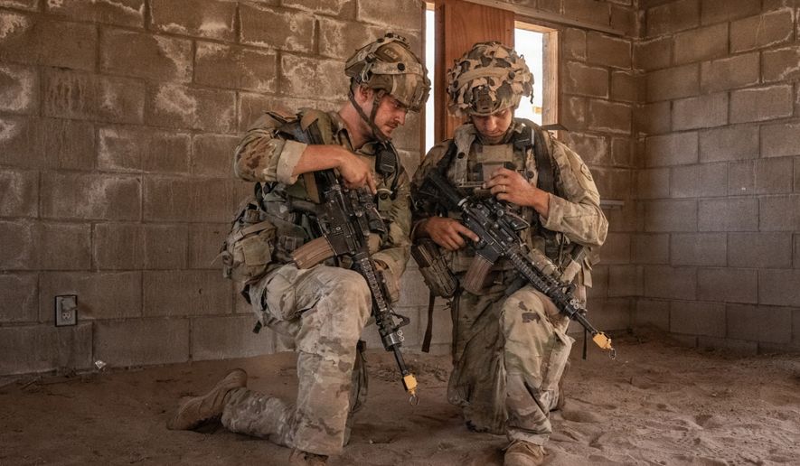 Soldiers assigned to Bravo Company, 1st Battalion, 8th Infantry Regiment, 3rd Armored Brigade Combat Team, 4th Infantry Division, plan on an end-user device during Project Convergence Capstone 6 at Fort Irwin, California, July 24, 2026. (U.S. Army photo by Spc. Jonathan Reyes via DVIDShub)