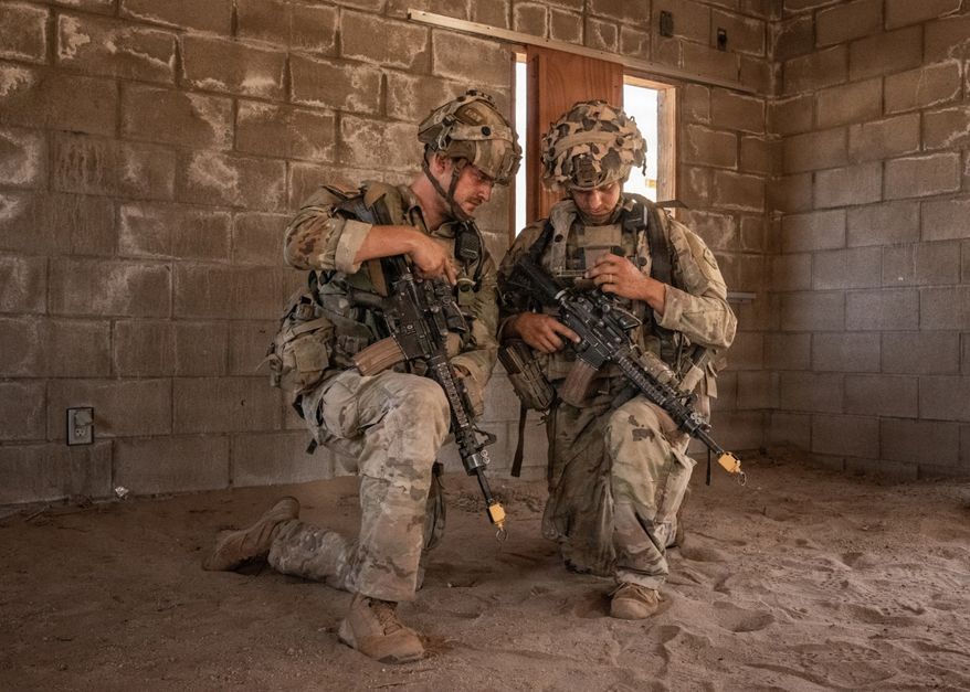 Soldiers assigned to Bravo Company, 1st Battalion, 8th Infantry Regiment, 3rd Armored Brigade Combat Team, 4th Infantry Division, plan on an end-user device during Project Convergence Capstone 6 at Fort Irwin, California, July 24, 2026. (U.S. Army photo by Spc. Jonathan Reyes via DVIDShub)