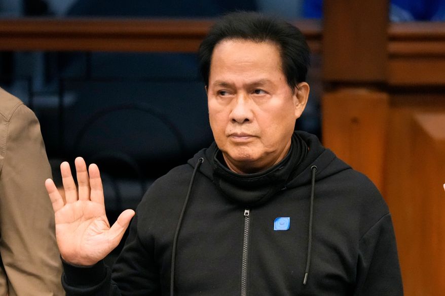 FILE - Apollo Quiboloy takes his oath as he attends a hearing at the Philippine Senate on Oct. 23, 2024, in Manila, Philippines. (AP Photo/Aaron Favila, File)