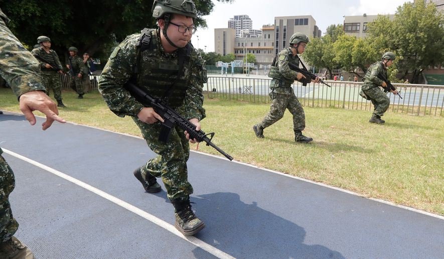 Soldiers attend the annual Han Kuang military exercises in Taipei, Taiwan, Wednesday, Aug. 5, 2026. (AP Photo/Chiang Ying-ying)