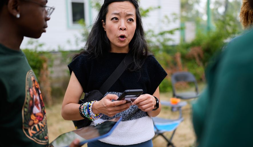 Democratic gubernatorial candidate Francesca Hong talks with Milwaukee residents during "We Outside" Annual Community Event at Metcalfe Park Rising, Friday, July 24, 2026, in Milwaukee. (AP Photo/Nam Y. Huh)