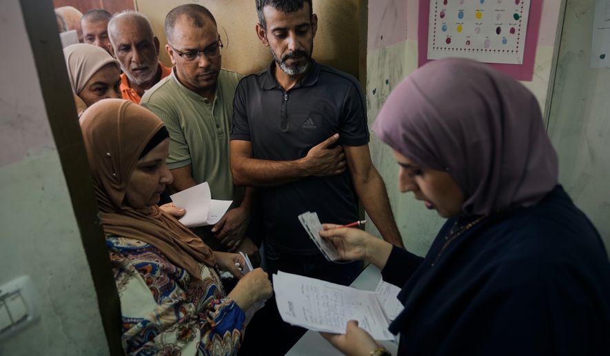 Palestinian patients line up for treatment at a mobile health clinic operated by Physicians for Human Rights Israel (PHRI) in the West Bank town of Iktaba, Tuesday, Aug. 4, 2026. (AP Photo/Majdi Mohammed)