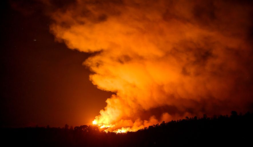 The Gann Fire burns along a hillside near Copperopolis on Tuesday, Aug. 4, 2026, in Calaveras County, Calif. (AP Photo/Noah Berger)